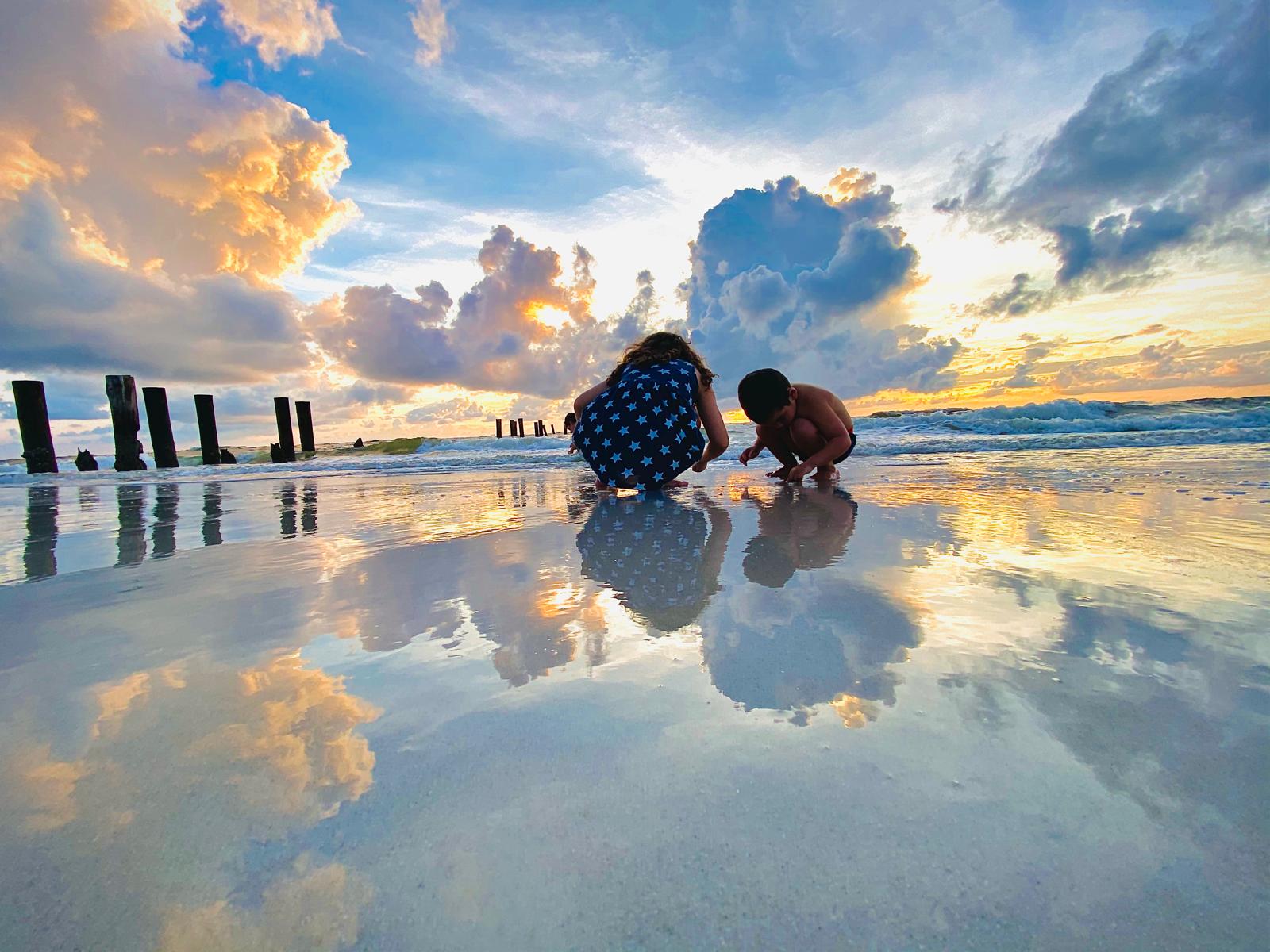 Children playing on a Miami beach at sunset